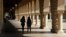 FILE - Students walk on the Stanford University campus, March 14, 2019, in Santa Clara, Calif.
