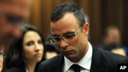 Oscar Pistorius leaves court in Pretoria, South Africa, March 28, 2014, after the trial was postponed.