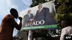 Campaign poster presenting the candidates of the Rally of Houphouetists for Democracy and Peace (RHDP) Ivorian President Alassane Ouattara (ADO) (R) and Albert Toikeusse Mabri of the UDPCI, in Kumasi, a popular district of Abidjan, Oct. 9, 2015. 
