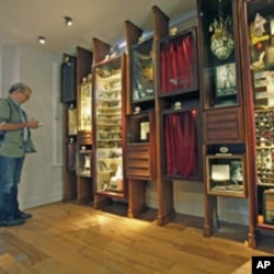 A journalist inspects artifacts from an exhibit at the Museum of Innocence in Istanbul, Turkey, April 27, 2012.