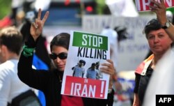 FILE - Women demonstrate against Iran's treatment of homosexuals during a gay pride parade in Berlin, June 19, 2010.