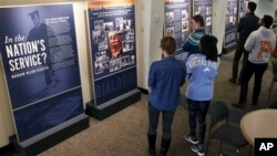 Princeton University students walk through an exhibit titled, "In the Nation's Service? Woodrow Wilson Revisited," April 3, 2016, at the Woodrow Wilson School of Public and International Affairs in Princeton, New Jersey.