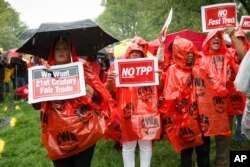 FILE - Demonstrators protest the Trans-Pacific Partnership at the Capitol in Washington, May 7, 2014.