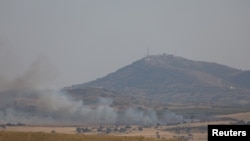 Smoke rises over Golan Heights as it's seen from Deraa area, Syria July 6, 2018. 