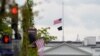 The American flag flies at half-staff over the White House in Washington, Friday, April 16, 2021. (AP Photo/Susan Walsh)