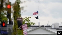 The American flag flies at half-staff over the White House in Washington, Friday, April 16, 2021. (AP Photo/Susan Walsh)