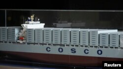 FILE - A scale replica of a COSCO cargo ship at the company's headquarters in Beijing, Nov. 8, 2013.