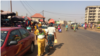 Des femmes quittant un marché de la banlieue de Conakry avec des sacs plastiques, en Guinée, le 17 janvier 2018. (VOA/Zacharia Camara)