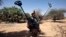 A French soldier carries mine detection equipment to search for mines outside Gao, Mali, March 9 2013. 