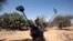 A French soldier carries mine detection equipment to search for mines outside Gao, Mali, March 9 2013. 