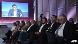 Ministers of the government watch the Greek Prime Minister Alexis Tsipras as he speaks during a press conference at the Thessaloniki International Fair (TIF) in Thessaloniki, northern Greece on Sept. 9, 2018. 