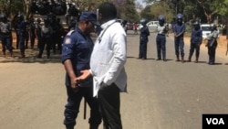 Doctors and police talking about protests in Harare.