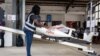 FILE - A staff member prepares a drone for the delivery of medical supplies at a service base run by operator Zipline, in Omenako, 70 kilometers north of Accra, Ghana, April 23, 2019.