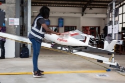 FILE - A staff member prepares a drone for the delivery of medical supplies at a service base run by operator Zipline, in Omenako, 70 kilometers north of Accra, Ghana, April 23, 2019.