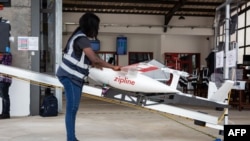 FILE - A staff member prepares a drone for the delivery of medical supplies at a service base run by operator Zipline, in Omenako, 70 kilometers north of Accra, Ghana, April 23, 2019.