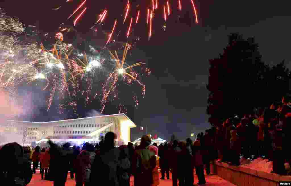 North Koreans watch fireworks to greet new year in Pyongyang early January 1, 2013 in this picture released by the North's official KCNA news agency. REUTERS/KCNA (NORTH KOREA - Tags: SOCIETY ANNIVERSARY) FOR EDITORIAL USE ONLY. NOT FOR SALE FOR MARKE