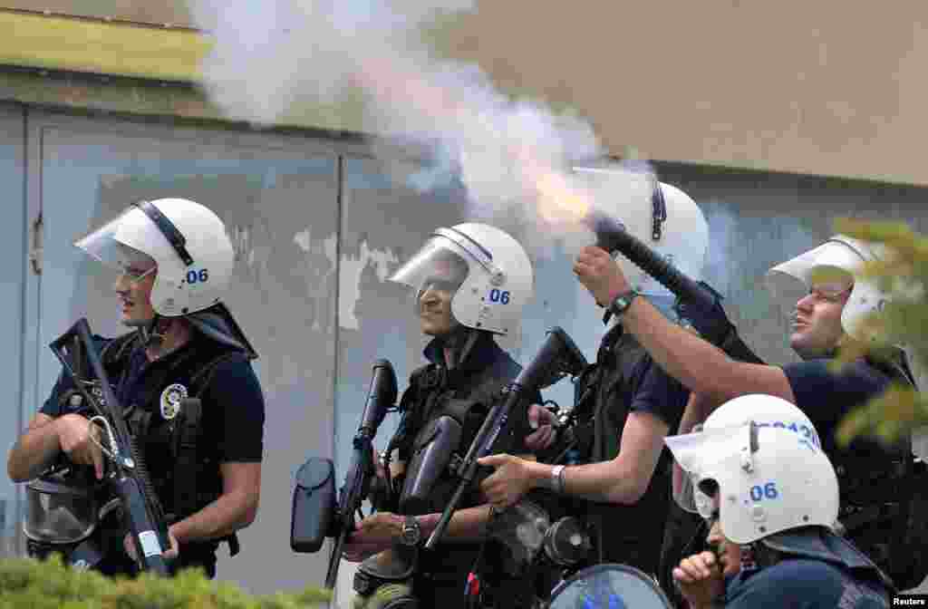 Riot police fire tear gas against protesters as they demonstrate to blame the ruling AK Party (AKP) government on the mining disaster in western Turkey, in Ankara May 14, 2014. Rescuers pulled more dead and injured from a coal mine in western Turkey on We