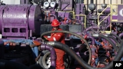 Pekerja di operasi perekahan hidrolik di sumur minyak Encana, negara bagian Colorado. (AP/Brennan Linsley)