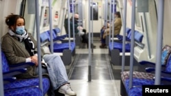 FILE - Commuters travel by underground inside an almost empty train, amid the coronavirus disease (COVID-19) outbreak, in London, Britain, Jan. 5, 2021. 