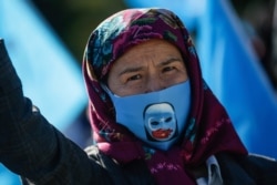 A protester from the Uighur community living in Turkey, participates in a protest in Istanbul, Oct. 1, 2020, against what they allege is oppression by the Chinese government to Muslim Uighurs in far-western Xinjiang province.