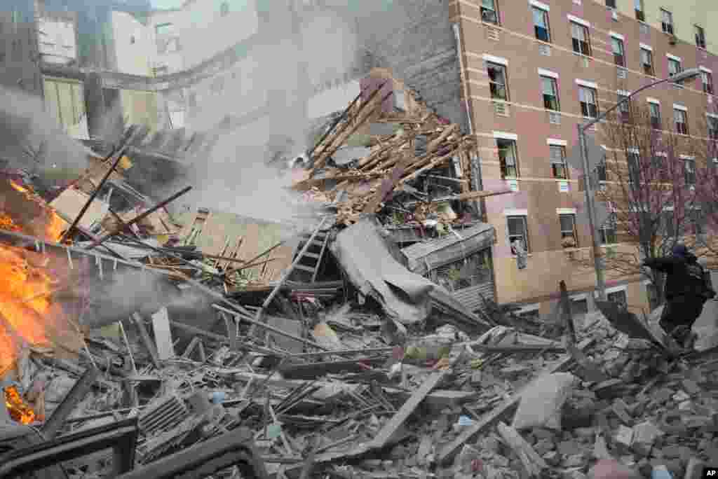 Emergency workers respond to the scene of an explosion that leveled two apartment buildings in Harlem, New York, March 12, 2014.