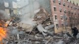 Emergency workers respond to the scene of an explosion that leveled two apartment buildings in the East Harlem neighborhood of New York.