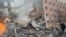 Emergency workers respond to the scene of an explosion that leveled two apartment buildings in the East Harlem neighborhood of New York.