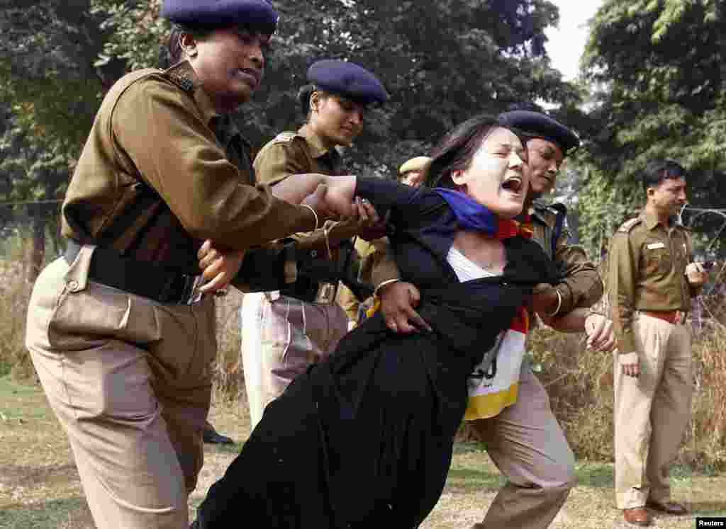 A Tibetan exile is detained by police during a protest over China&#39;s rule over Tibet, outside the Chinese embassy in New Delhi, India.