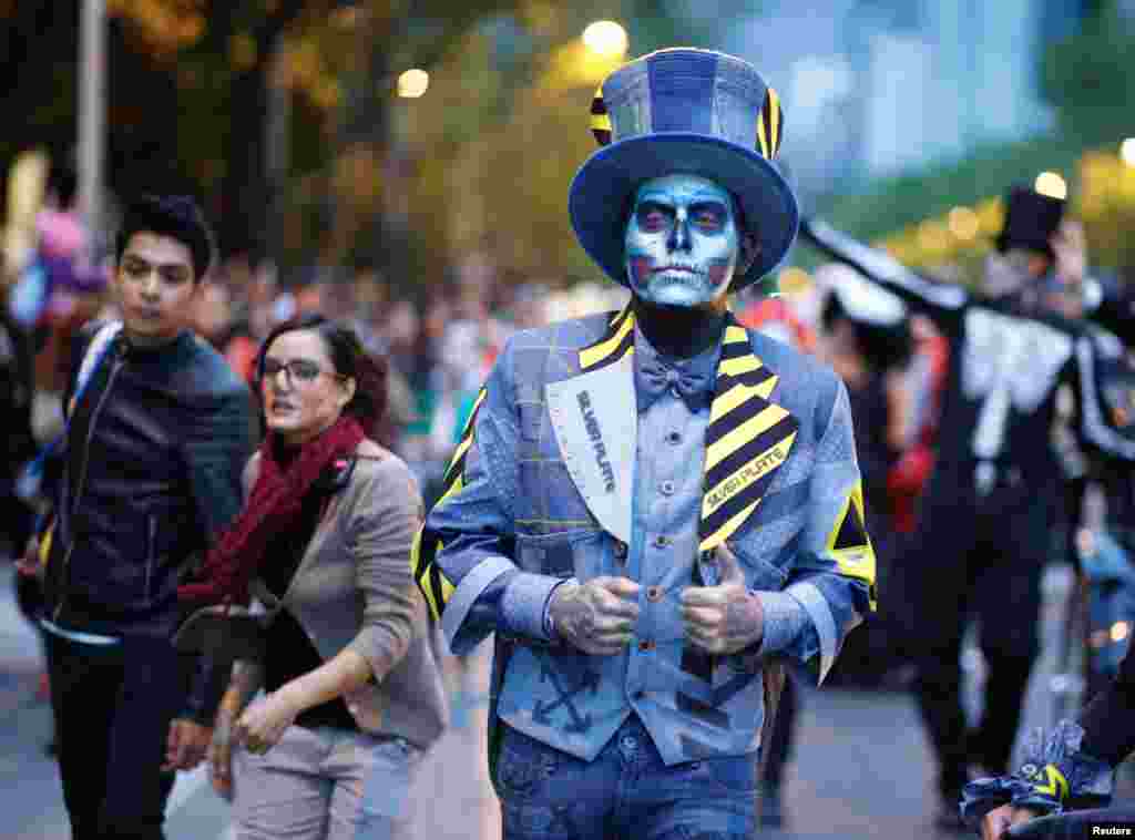 People participate in a Catrina parade ahead of the Day of the Dead in Mexico City, Mexico, Oct. 21, 2018.