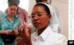 A Rwandan nurse prepares a dose of Prevenar, a pneumococcal vaccine. The South African government has also made the vaccine part of its national immunization program.