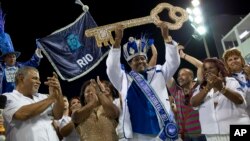Carnival King Momo, Fabio Damiao dos Santos Antunes, holds up the key to the city at a ceremony marking the official start of Carnival in Rio de Janeiro, Brazil, Feb. 24, 2017.