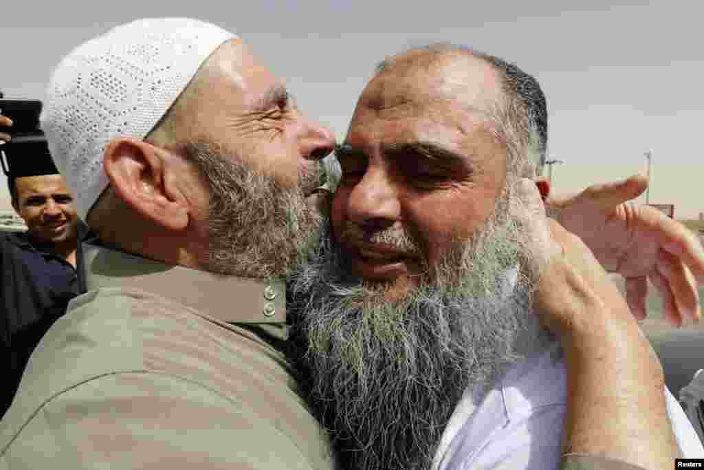 Abu Qatada hugs his father after being released from Mwaqar 2 prison near Amman, Sept. 24, 2014.