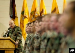 FILE - H.R. McMaster, then the regimental commander, looks to the soldiers during the 3rd Armored Cavalry Reenlistment Ceremony at Waller Gym at Fort Carson in Colorado Springs, Colo., Dec. 1, 2004.