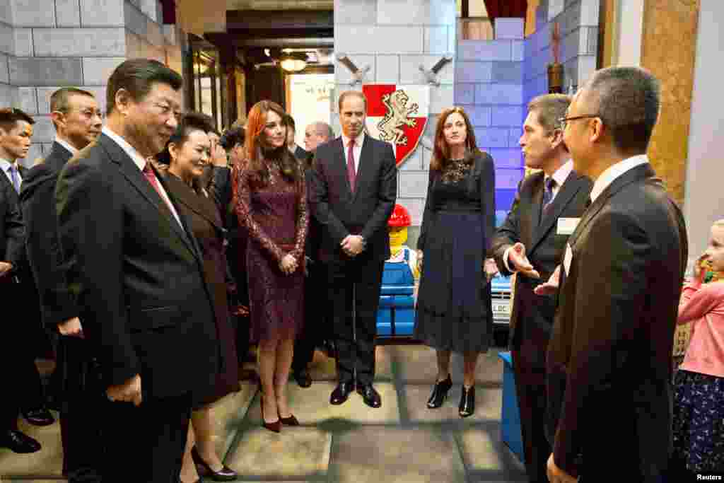President Xi Jinping and his wife Peng Liyuan stand with Prince William and Catherine, Duchess of Cambridge as they attend a creative industry event at Lancaster House in London, Britain, Oct. 21, 2015.