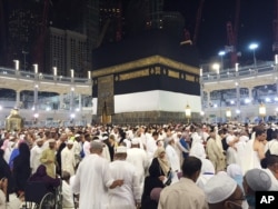 Muslim pilgrims walk around around the Kaaba, the cubic building at the Grand Mosque in the Muslim holy city of Mecca, Saudi Arabia, early Saturday morning, Sept. 12, 2015.