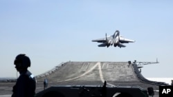 FILE - In this undated photo released on Dec. 31. 2021, by Xinhua News Agency, a carrier-based J-15 fighter jet takes off from the Chinese Navy's Liaoning aircraft carrier. The Chinese navy wants to hire graduate students to fly shipborne aircraft.