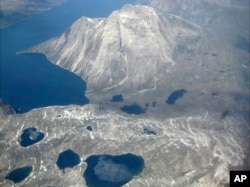 FILE - Melt water lakes are seen on the edge of an ice cap in Nunatarssuk, Greenland, in this aerial view taken on June 22, 2019.