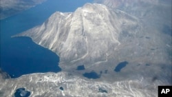 FILE - Melt water lakes are seen on the edge of an ice cap in Nunatarssuk, Greenland, in this aerial view taken on June 22, 2019. 