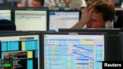 FILE - Traders react as European stock markets open early June 24, 2016, after Britain voted to leave the European Union.