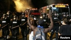 Police officers wearing riot gear block a road during protests after police fatally shot Keith Lamont Scott in the parking lot of an apartment complex in Charlotte, North Carolina, September 20, 2016.