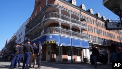 Law enforcement gather in front of the Sonesta Hotel on Bourbon Street, Jan. 2, 2025 in New Orleans.