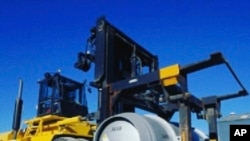 FILE - In this photo released on Nov. 6, 2019 by the Atomic Energy Organization of Iran, a lift truck carries a cylinder containing uranium hexafluoride gas for the purpose of injecting the gas into centrifuges in Iran's Fordo nuclear facility.