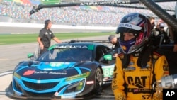 Katherine Legge of England waits to drive during a test session at Daytona International Speedway in Daytona Beach, Fla., Friday, Jan. 4, 2019. Legge is part of an all-female-driver team racing in the Rolex 24 at Daytona later this month. (AP Photo/Mark Long)