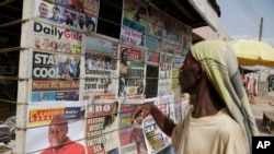 A man looks at local newspapers on a street in Accra, Ghana, Dec. 9, 2016. Incumbent President John Mahama conceded defeat Friday evening and telephoned congratulations to the victor, Nana Akufo-Addo.