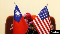 FILE - Flags of Taiwan and the United States are placed on a table before a meeting between Taiwanese and American lawmakers, in Taipei, Taiwan, March 27, 2018.