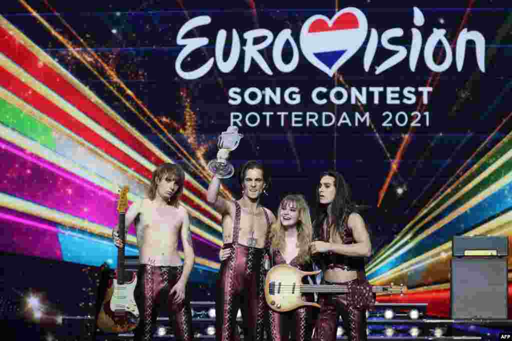 Italy&#39;s Maneskin pose for pictures on stage with the trophy after winning the final of the 65th edition of the Eurovision Song Contest 2021, at the Ahoy convention centre in Rotterdam, May 22, 2021.