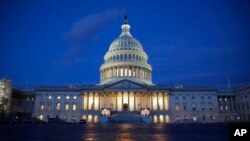 FILE - ight shines on the U.S. Capitol dome in Washington, early Wednesday, Dec. 4, 2019. 