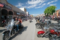 FILE - Thousands of bikers rode through the streets for the opening day of the 80th annual Sturgis Motorcycle rally, Aug. 7, 2020, in Sturgis, S.D.