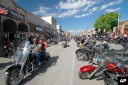 FILE - Thousands of bikers rode through the streets for the opening day of the 80th annual Sturgis Motorcycle rally, Aug. 7, 2020, in Sturgis, S.D.