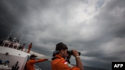 Indonesian national rescue personnel conduct search for missing Malaysia Airlines flight MH370, Andaman Sea, March 15, 2014.